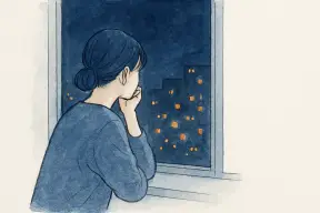 夜の街並みを窓越しに見つめて考え込む女性の後ろ姿