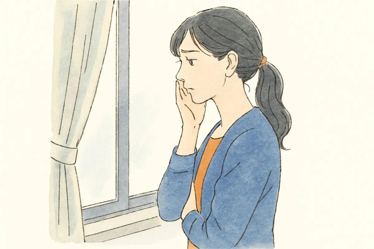 窓辺で結婚を前に不安げに考え込む女性の横顔